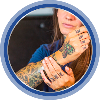 A close-up of Bepanthen Tattoo Intense Care Ointment being held in someone’s hand