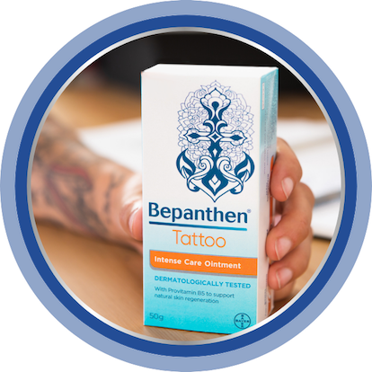 A close-up of Bepanthen Tattoo Intense Care Ointment being held in someone’s hand